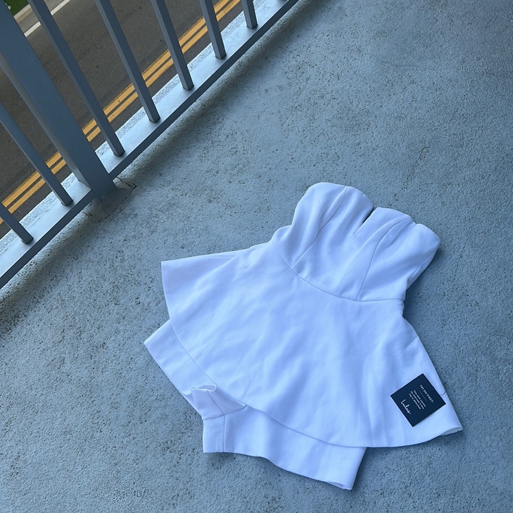 Lulu’s cute white romper with a peplum 🥰